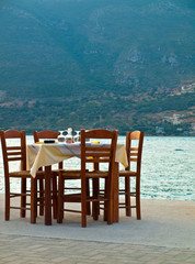 Table prepared for dinner in Vasiliki harbor Greece