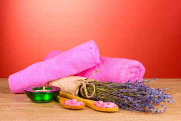 Beautiful lavender, salt and towels on a red background