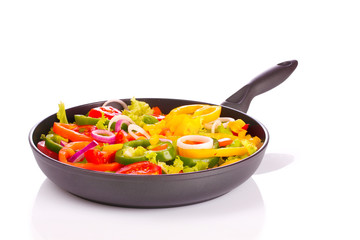 sliced ​​vegetables in a pan isolated on white