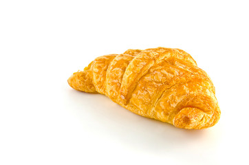 Single fresh croissant, casting soft shadow on white. Delicious.