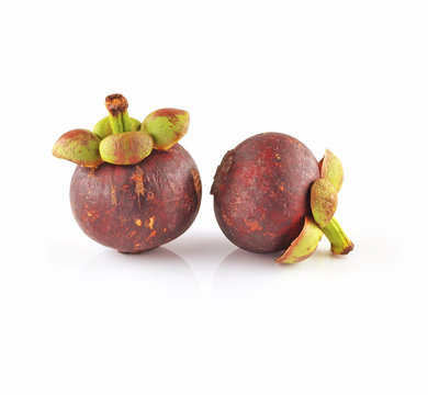 Two mangosteens isolated on white
