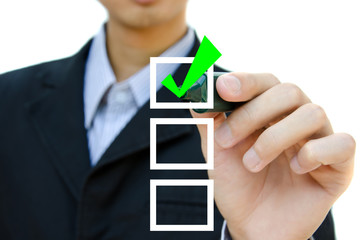 Young business hand with pen mark the check boxes.