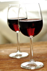 Two glass of fine Italian red wine on a table in oak