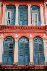 Fototapeta na wymiar Old red building and green windows from singapore china town