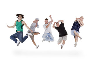 Group of young teenagers jumping over white