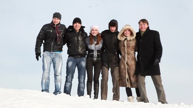 Group of young people start sway on slope with snow
