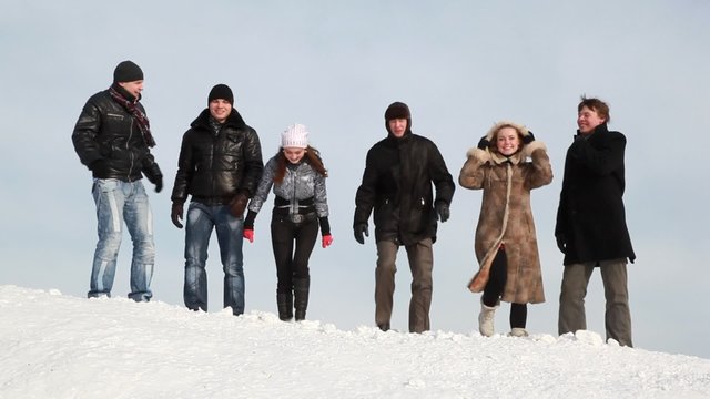 Group Of Young People Are Laughing On Slope With Snow