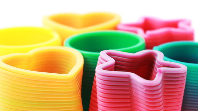 Seven toys-springs in form of rings, hearts and stars revolve