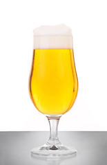Glass of beer against white background