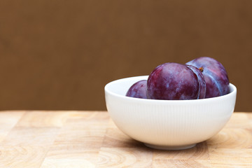 Plumbs in a White Bowl