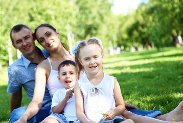 Family with two children in the summer park