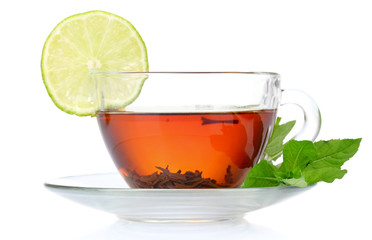 black tea in cup, mint and lime isolated on white