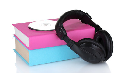 Headphones on books and disc isolated on white