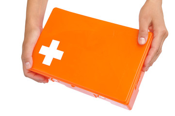 Hands of young woman holding first aid kit