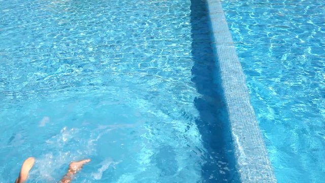 Boy stood on parapet prepared and jumped into the water
