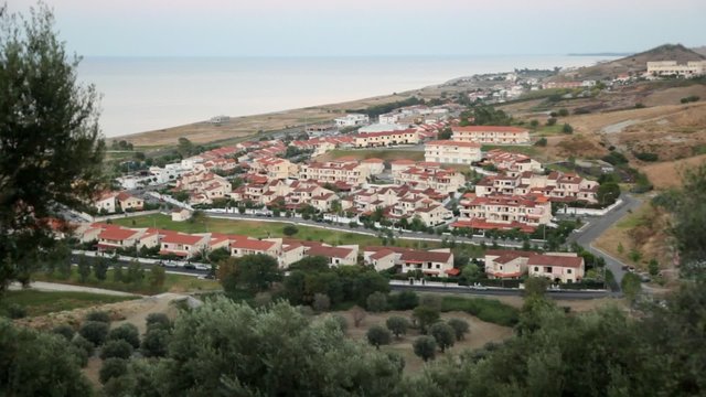View from hill of costal village, sea and hills has shown