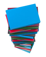 Books pile on white background top view.