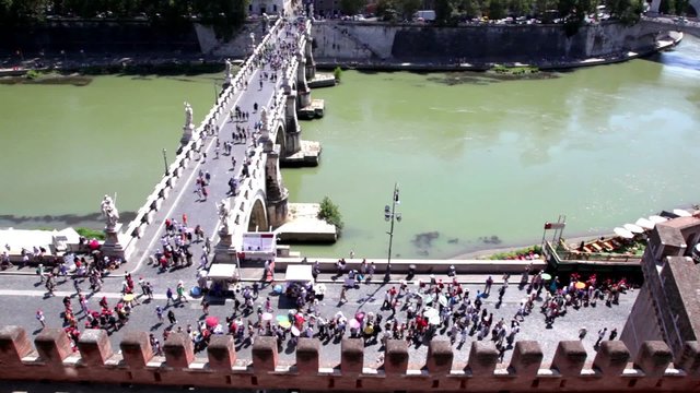 Bridge, street traffic on one riverside and quay with tourists