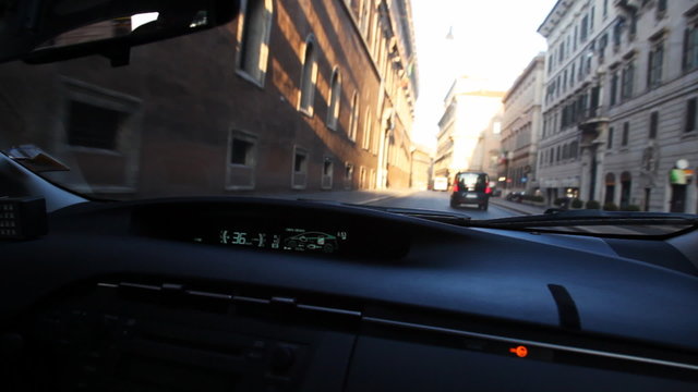 Driving inside car through streets in city