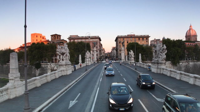 Riding through bridge Ponte Vittorio Emanuele II across Tiber