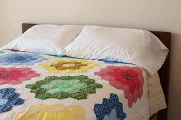 Bed with antique floral quilt