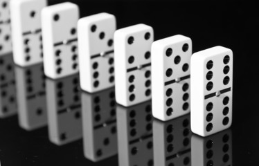 Dominoes on black shining surface