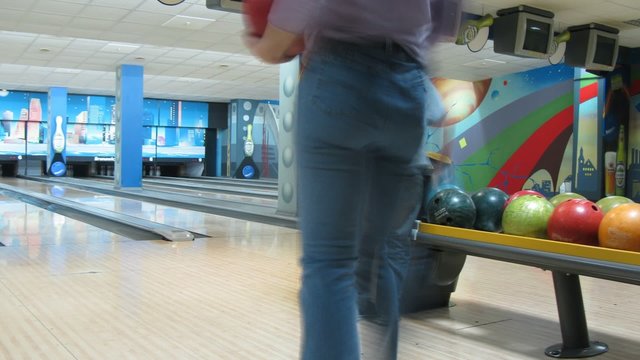 Family play bowling in club