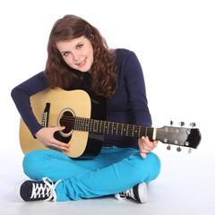 Cute smile by teenager girl on acoustic guitar