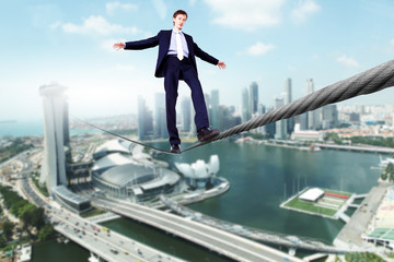 Business man balancing on the rope
