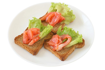 toasts with salmon on a plate