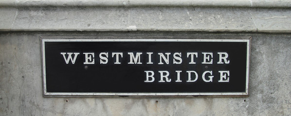 closeup of a westminster bridge sign