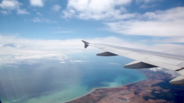 Ground under wing of an airplane during flight