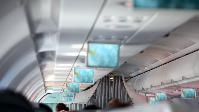Aircraft cabin, under ceiling hung displays