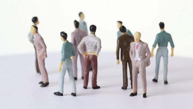 Several painted toy men stand and drop shadows