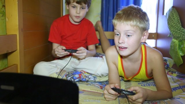 Two boys play a computer game