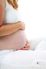 pregnant belly in closeup over white background
