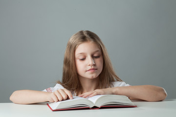 girl at the table reading a book