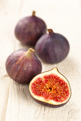 Whole and halved figs on a wooden board
