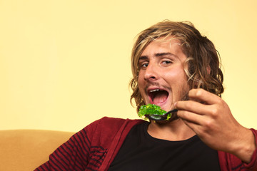 Young handsome man enjoying green jelly