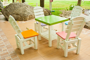 four colorful chairs and a table