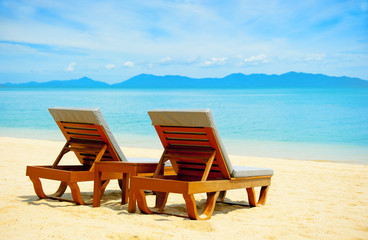 Fototapeta na wymiar Chairs on the beach near sea