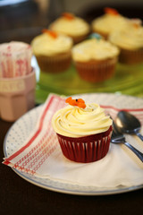 cup cake close, a chocolate cup cake with white cream on top.