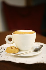 hot cappuccino, a cup of hot cappuccino with cookie.