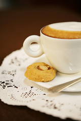 cappuccino cookie, a cup of hot cappuccino with cookie.
