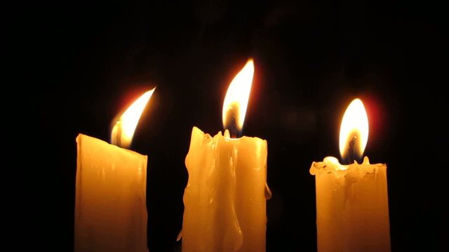 Three Candles in the wind at night