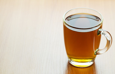 glass cup of tea on a wooden table