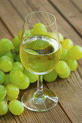 wine and grapes on wooden table