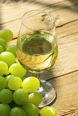 wine and grapes on wooden table
