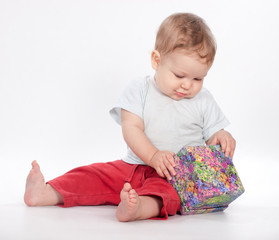 Fototapeta premium baby boy opening gift box on white