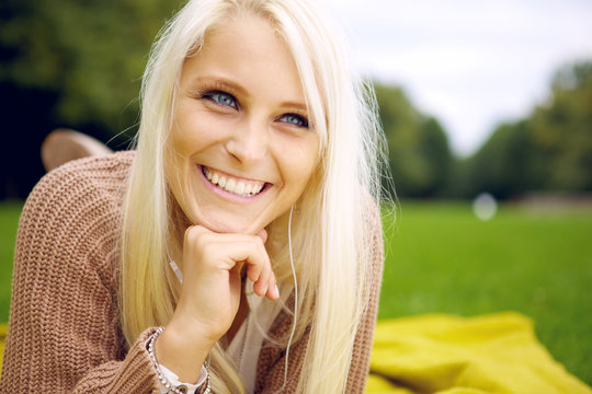 Happy woman lying in a park